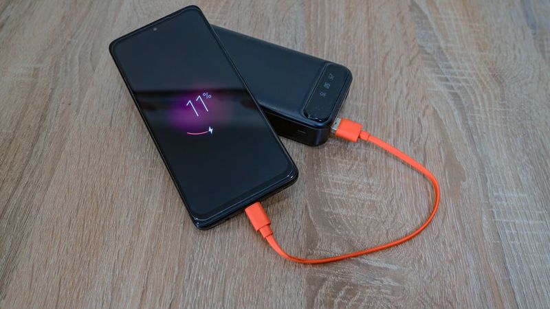 Phone at 11% charging from a power bank