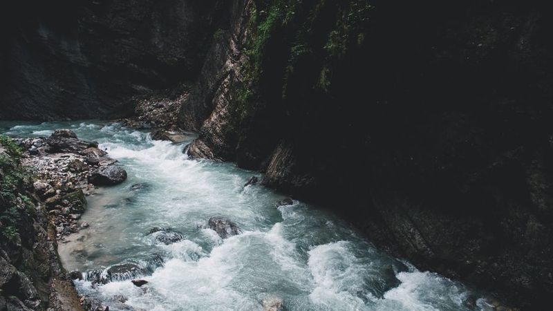 Fast wild stream running through a dark gorge